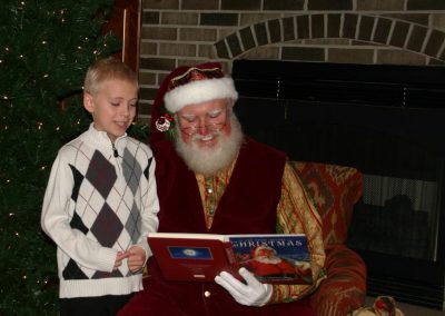 Santa Dan Reading To Young Boy