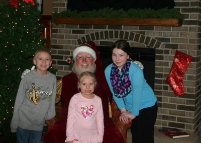 Santa Dan Group Photo By The Fireplace