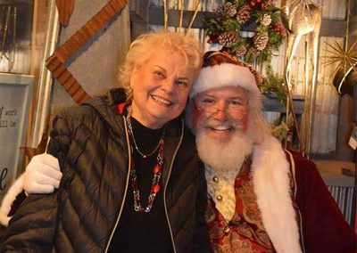 Santa Dan On Main Street from Kennedy's Cafe With Lady Smiling