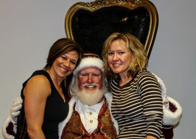 Santa Dan & Two Ladies Smiling